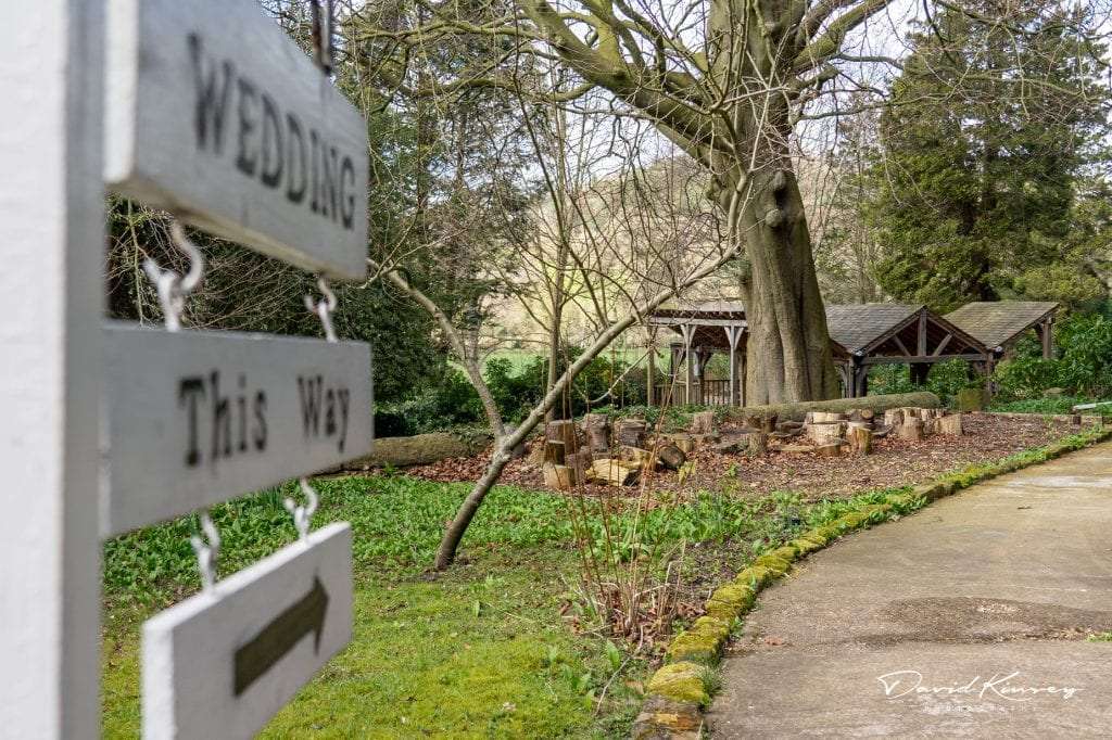 Makeney Hall Wedding Photographer. Wedding This Way Sign pointing to the outdoor wedding ceremony area at Makeney Hall