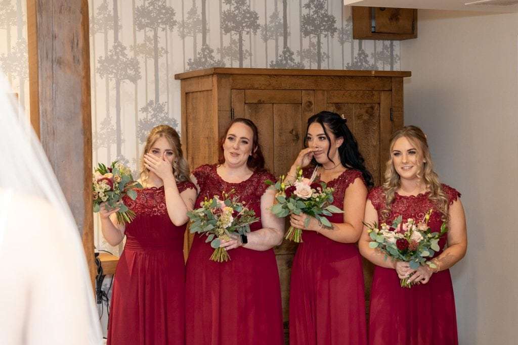 Makeney Hall Wedding Photographer. Four bridesmaids reacting to seeing the bride in her dress for the first time