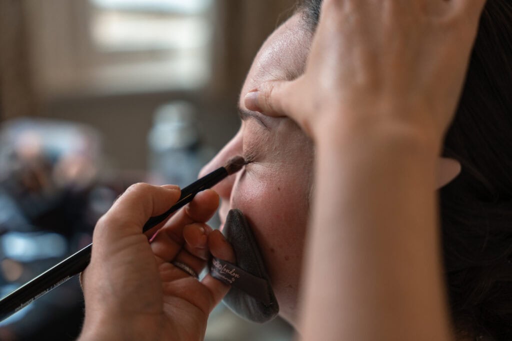 Person applying eyeshadow with brush